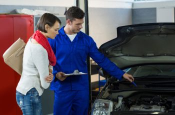 mechanic-showing-customer-problem-with-car